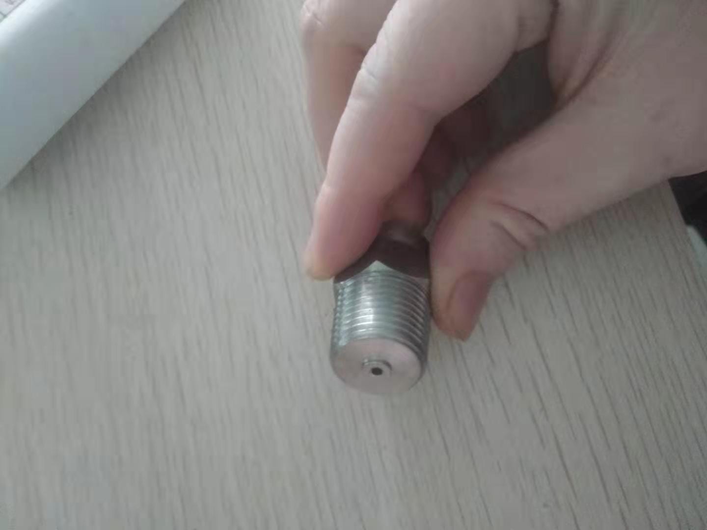 Front-angle view of a 1/4-inch NPT male thread adapter