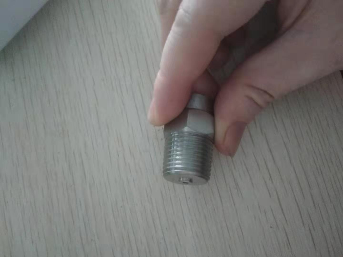 Close-up side view of a 1/4-inch NPT male thread adapter