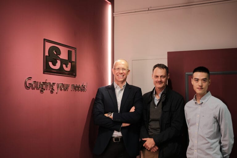 Visiting customers with the SJ Gauge team in front of the company logo